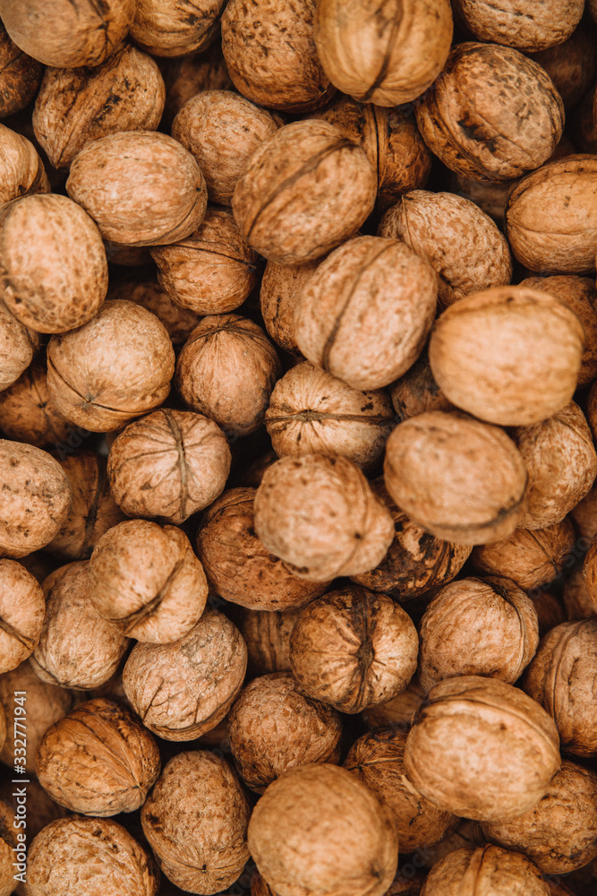 Lots of walnuts. Background and texture from the nuts. Close up. Lots of walnuts. Background and texture from the nuts. Close up.