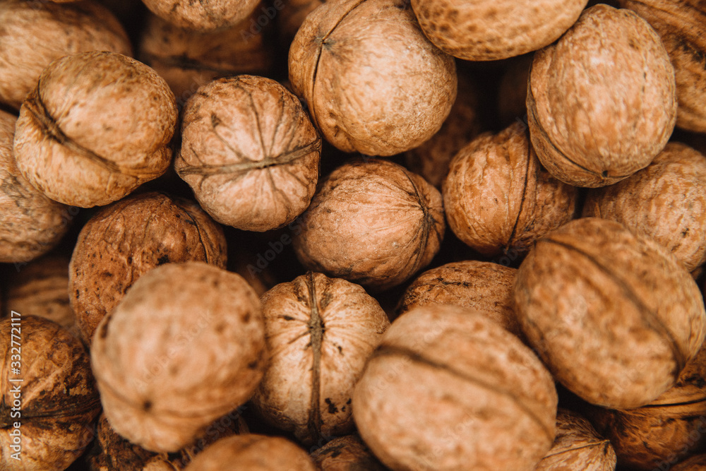 Lots of walnuts. Background and texture from the nuts. Close up.