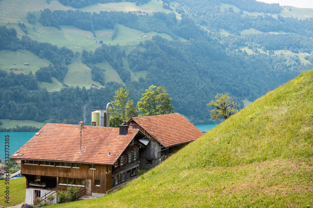 Traditional swiss houses with lake view. Lungerersee, canton of Obwalden, Switzerland