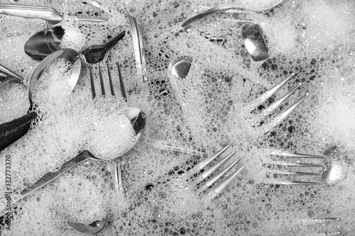 Canvas-taulu Washing silverware in the sink with soap suds. Cleaning concept