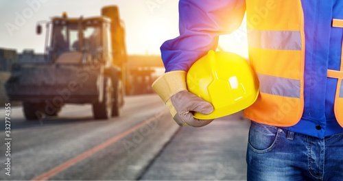 Vászonkép Worker man with helmet in hands on background