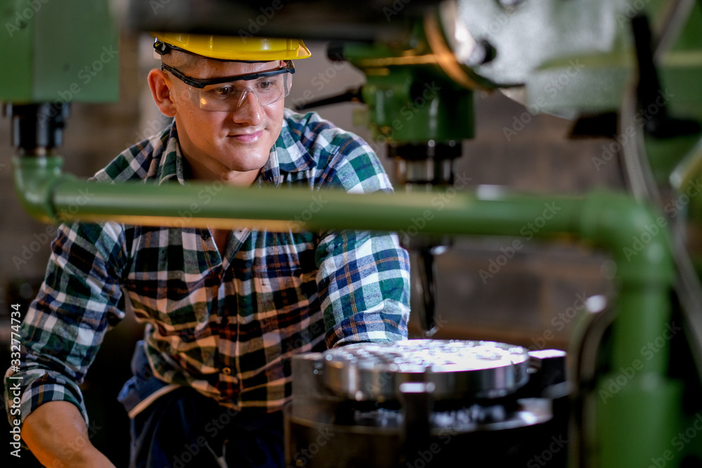 Technician or worker man work with the machine in factory with day light. Technician or worker man work with the machine in factory with day light.