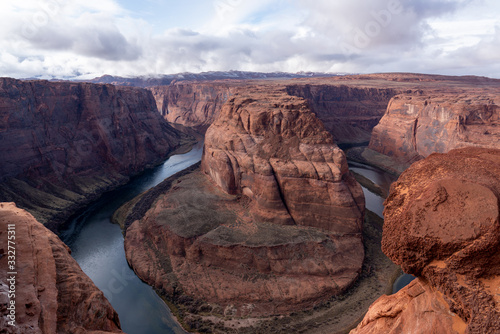 Famous Landmark - Horseshoe Bend with Colorado River running through is near Page. Arizona, USA, 5 miles outside Grand Canyon National Park. Bend Framed by red sandstone and cloudy blue sky