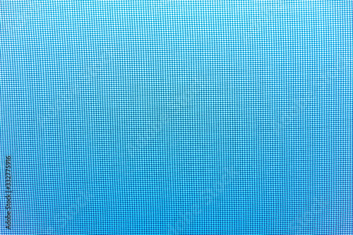 light background: sky blue light visible through a mosquito net
