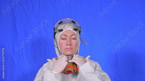 Scientist virologist in respirator. Slow motion. Woman close up look, wearing protective medical mask. Concept health safety N1H1 virus protection coronavirus epidemic 2019 nCoV. Chroma key blue. photo