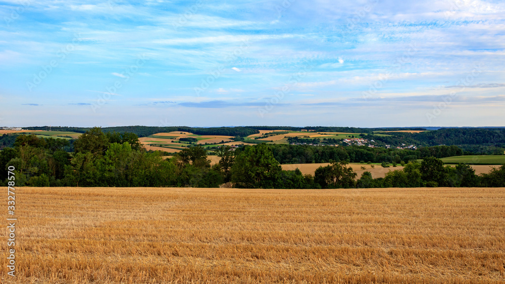 rural landscape with harvested wheat field and blue sky in Möckmühl, Germany