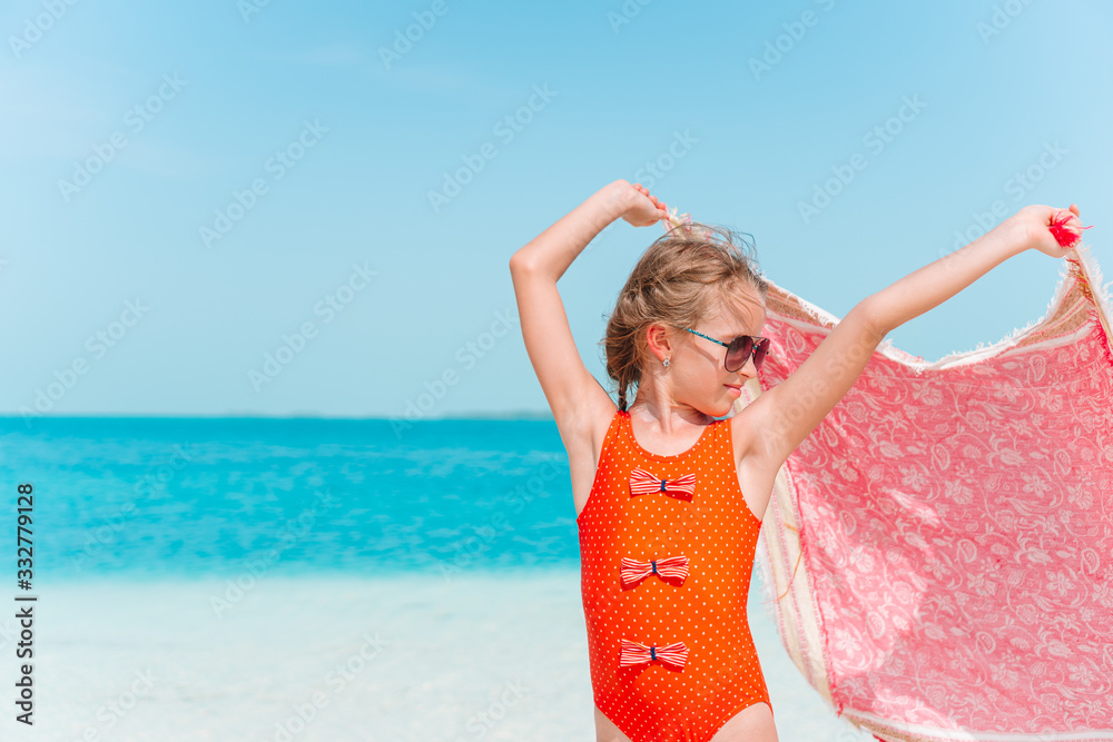 Adorable happy little girl have fun on beach vacation