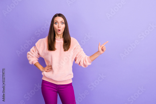 Photo of attractive lady open mouth indicating finger empty space presenting new clothes store low prices wear casual soft fuzzy pullover trousers isolated purple color background © deagreez