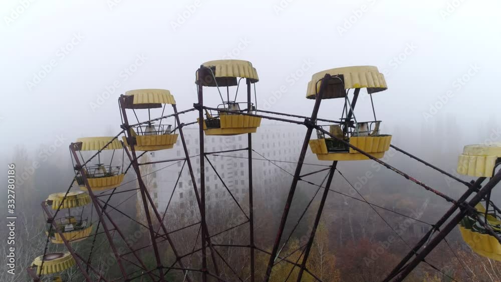An abandoned ferris wheel in the Pripyat city amusement park. Video from the drone in the fog. Autumn. An abandoned ferris wheel in the Pripyat city amusement park. Video from the drone in the fog. Autumn.