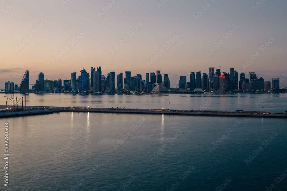 Panoramic view to Doha business center with skyscrapers after sunset