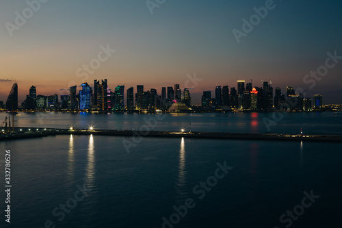 Panoramic night view to Doha city skyscrapers from the sea