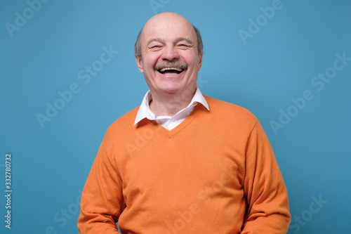 Laughing senior handsome man having great mood feeling positive. © Viktor Koldunov