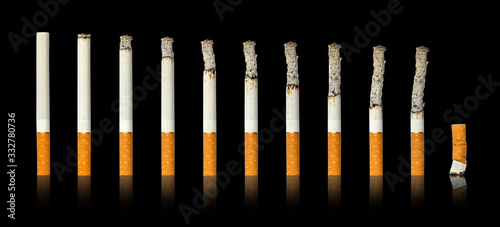 Cigarettes burning and extinguished cigarette black isolated background.