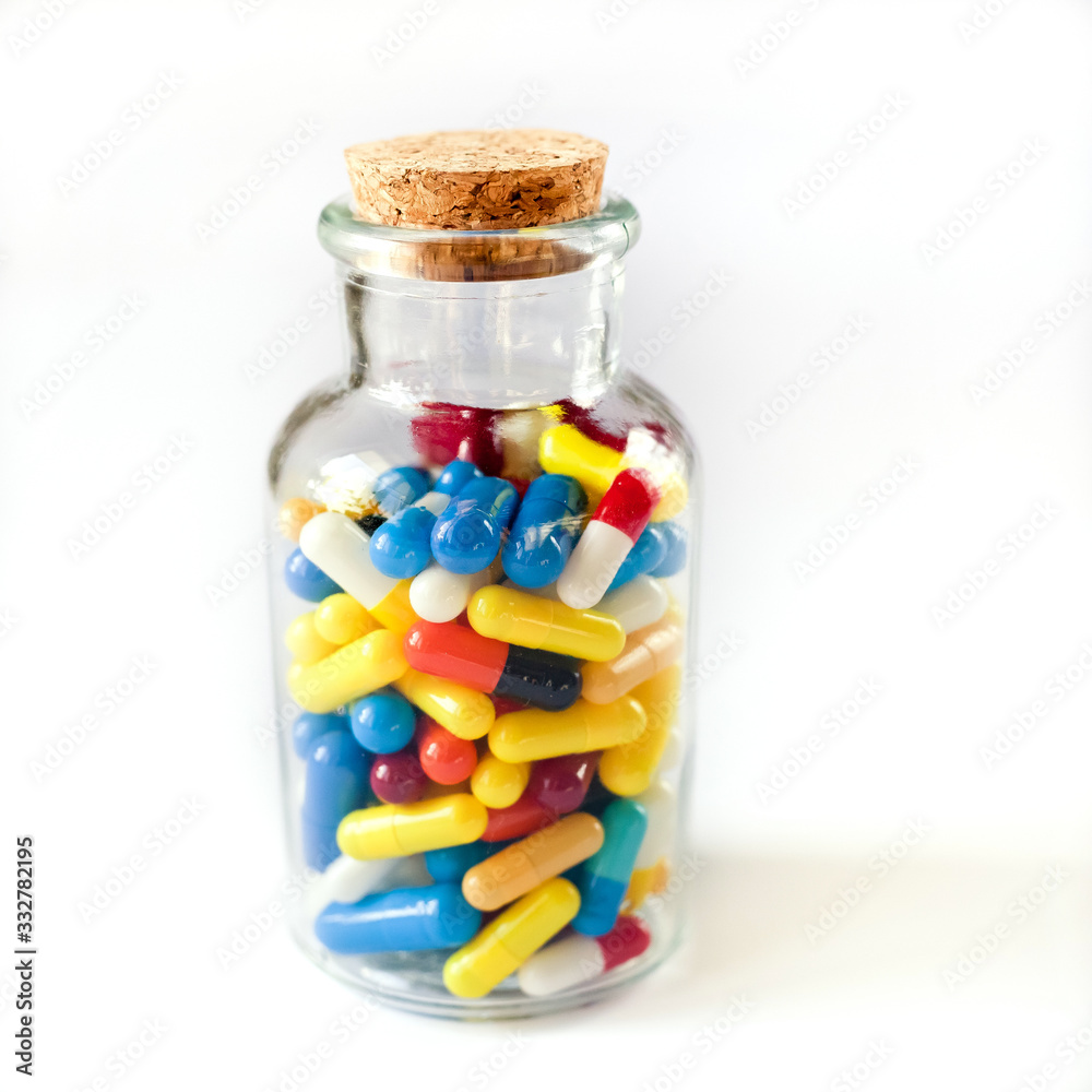 Colorful medicine capsules in a transparent bottle, on white background, isolate Colorful medicine capsules in a transparent bottle, on white background, isolate