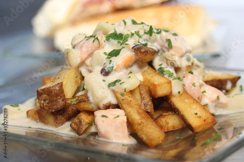 Smoked Seafood Poutine on a Glass Plate