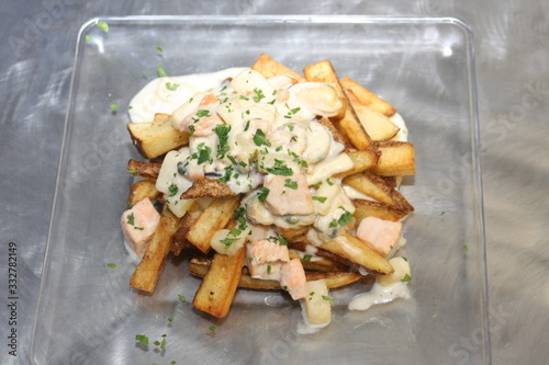 Smoked Seafood Poutine on a Glass Plate