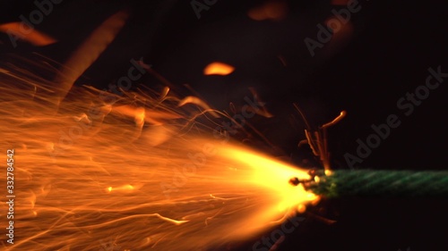 Close up macro shot of Burning fuse firecracker. Setting fire to wick of bomb photo