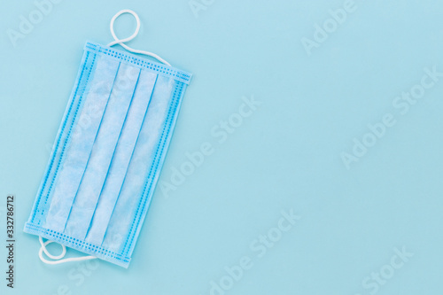 Protective medical mask on a blue background. Bacteria mask procedure. Protection concept