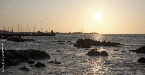 a view of the sunset in the atlantic sea from the rocks of the port of Punta del Este, Maldonado, Uruguay