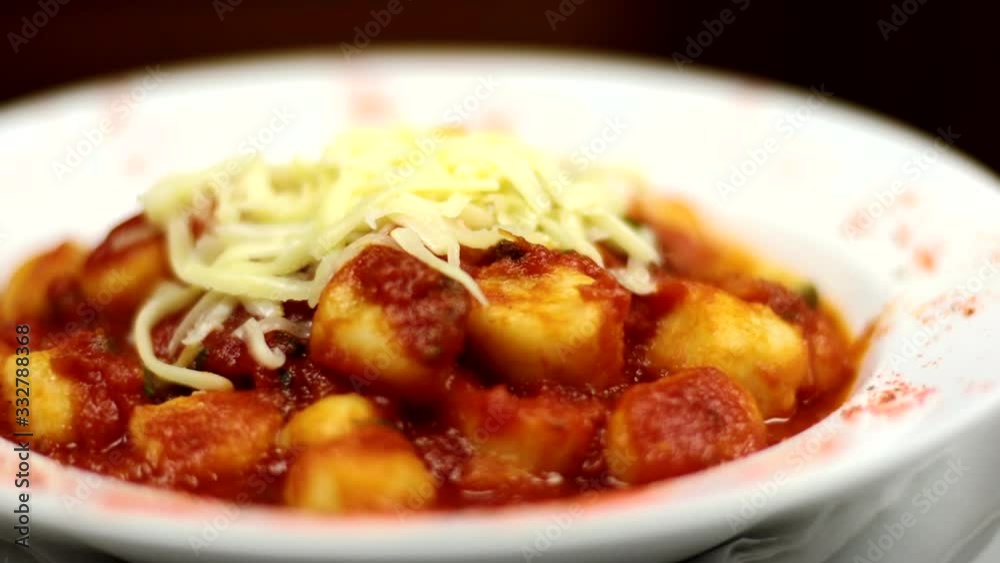 Gnocchi with tomato sauce and grated cheese on top Gnocchi with tomato sauce and grated cheese on top