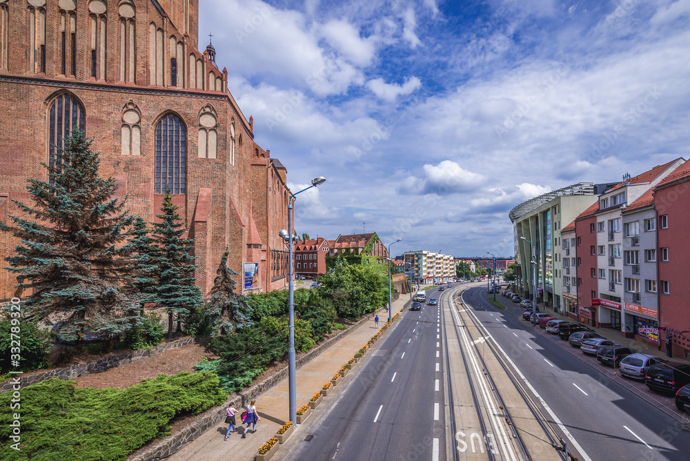 Fototapeta premium Stefan Wyszynski Street in Szczecin city, view with Saint James the Apostle Cathedral in Szczecin city, Poland