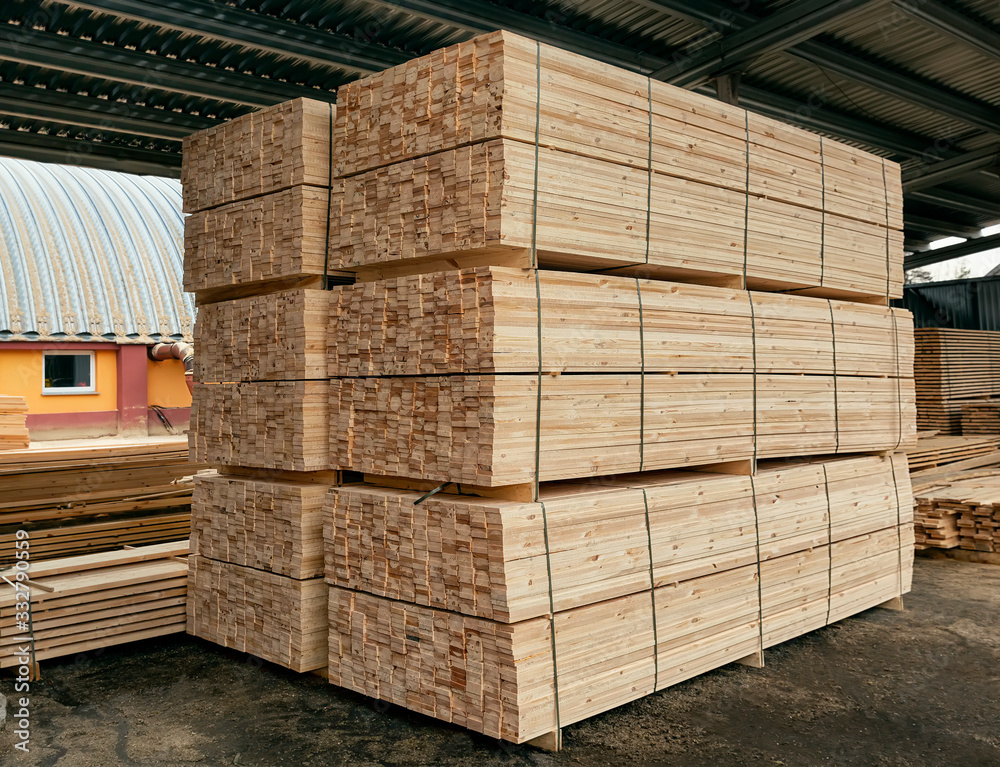 Packed boards, lumber piles in the finished goods warehouse Packed boards, lumber piles in the finished goods warehouse