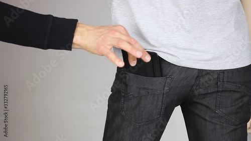 pickpocket thief gently steal leather purse from pants back pocket, pickpocketing theft crime, close-up