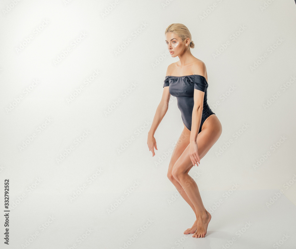 Portrait of sexy blonde woman in black dress in studio. Portrait of sexy blonde woman in black dress in studio.