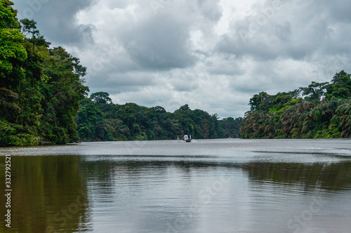 Small boat sailing into the canals of Tortuguero