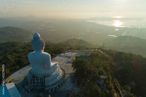 Big buddha over high mountain in Phuket thailand Aerial view drone shot in the morning.