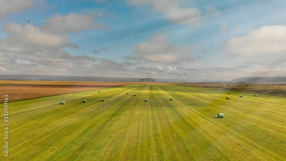 Aerial view of iceland meadows with hay bales in summer season