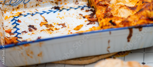 Tray of lasagne, tasteful food on a italian table photo