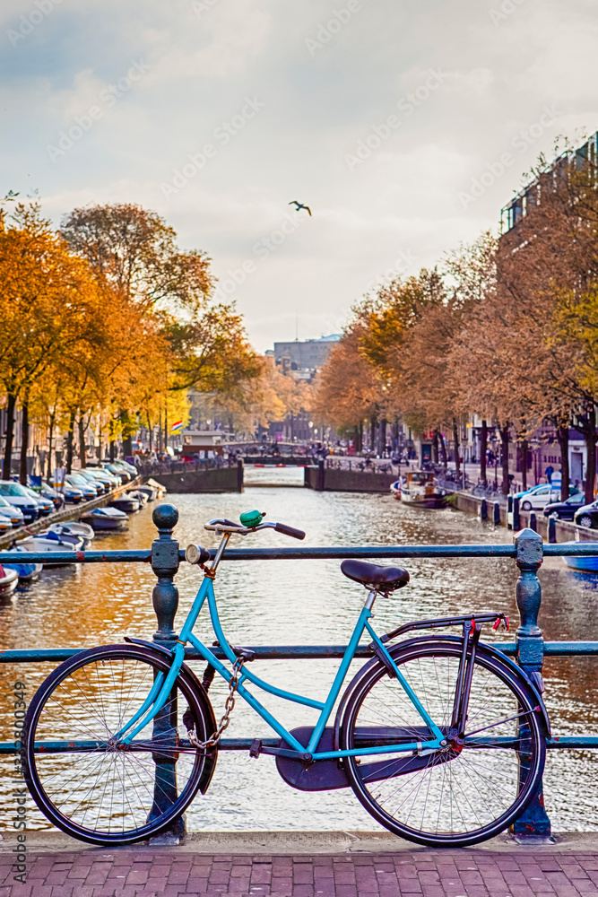 Travel Ideas. City of Amsterdam. Traditional Dutch Bicycle In Front of The Canal Fence in Amsterdam.