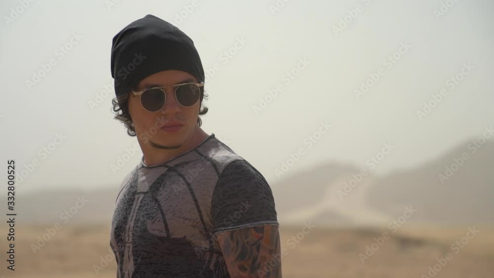 The guy on the roof of the car travels through the desert The guy on the roof of the car travels through the desert