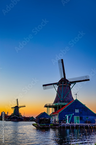 Dutch Travel Concepts. Two Traditional Dutch Windmills in the Village of Zaanse Schans at Daytime in the Netherlands. photo