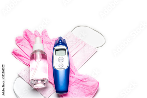 Medical gloves surgical mask, sanitizer gel, modern thermometer - Virus protection equipment on white background. China pathogen respiratory coronavirus 2019-ncov flu outbreak medical concept photo