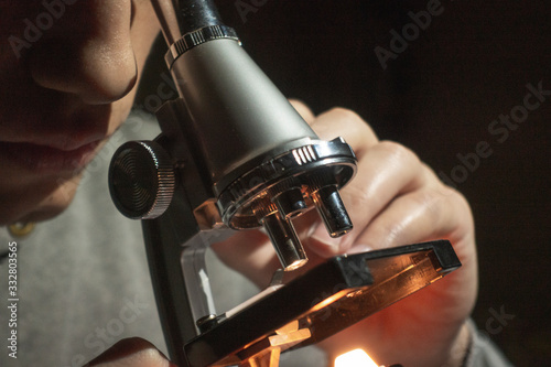 Plakat Scientist looking through his microscope