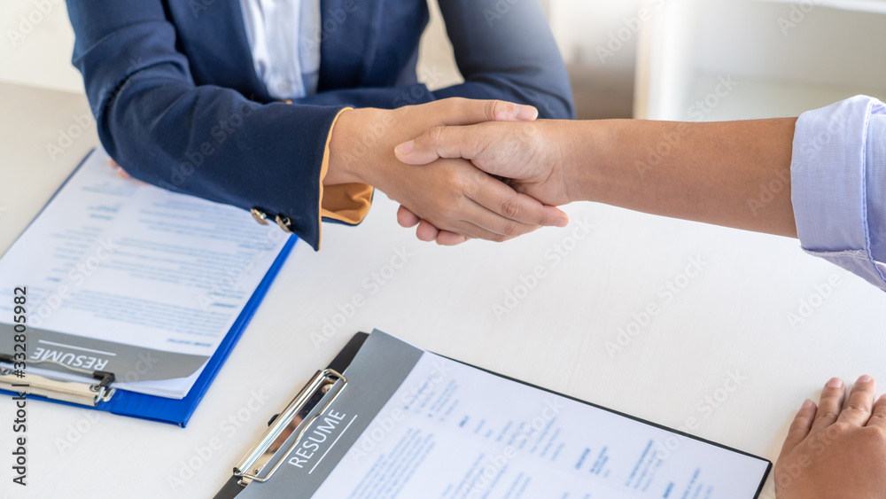 Cheerful interviewer hr manager welcoming women applicant at job interview handshaking at group meeting talk and effective negotiation Cheerful interviewer hr manager welcoming women applicant at job interview handshaking at group meeting talk and effective negotiation
