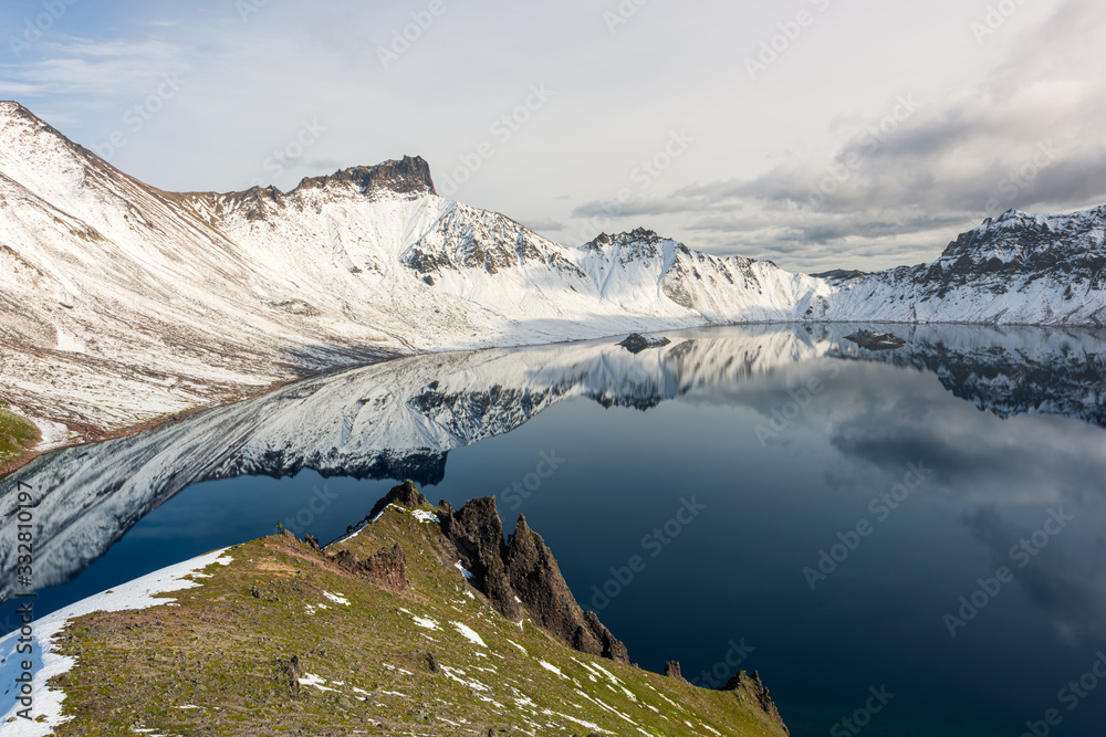 Tolbachik volcano reflection in the quiet mountain lake, Kamchatka
