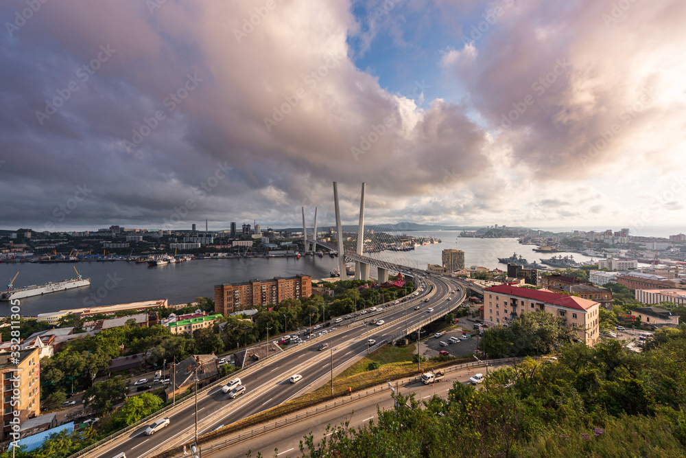 Panorama of Vladivostok at sunset, Far East Russia. Golden bridge.