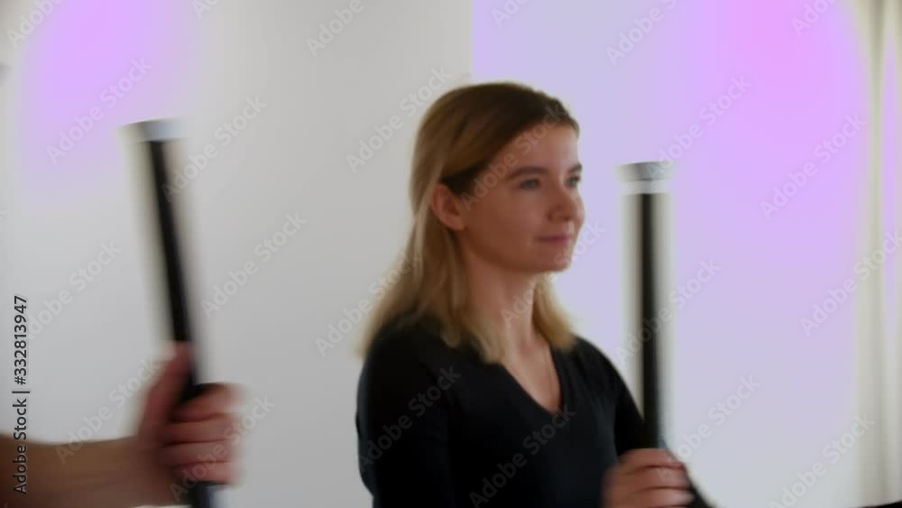 A young woman doing exercises on exercise bike A young woman doing exercises on exercise bike