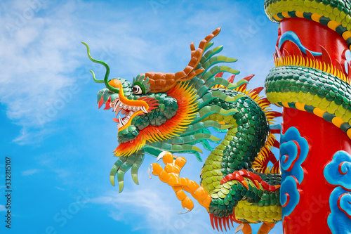 Colorful chinese dragon statue in blue sky background © apimook