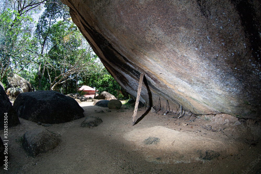 Fototapeta premium A huge stone backed by sticks in Sri Lanka.
