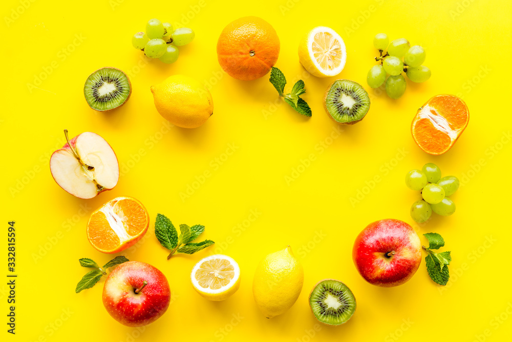 Colorful fruit mockup. Cut apple, kiwi, citrus on yellow background top-down copy space Colorful fruit mockup. Cut apple, kiwi, citrus on yellow background top-down copy space