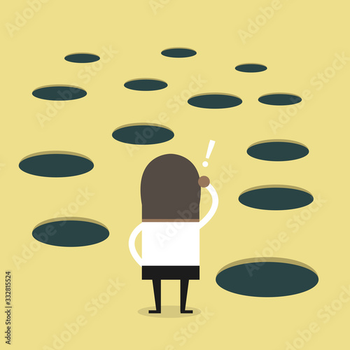 African businessman looks at hole on the ground.