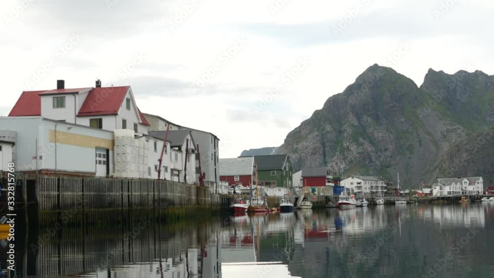 Docked boats in the beautiful seaside village of Henningsvær, Norway, on a calm morning Docked boats in the beautiful seaside village of Henningsvær, Norway, on a calm morning