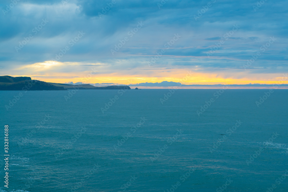 Sunrise and sea at Curio Bay Cliffs New Zealand