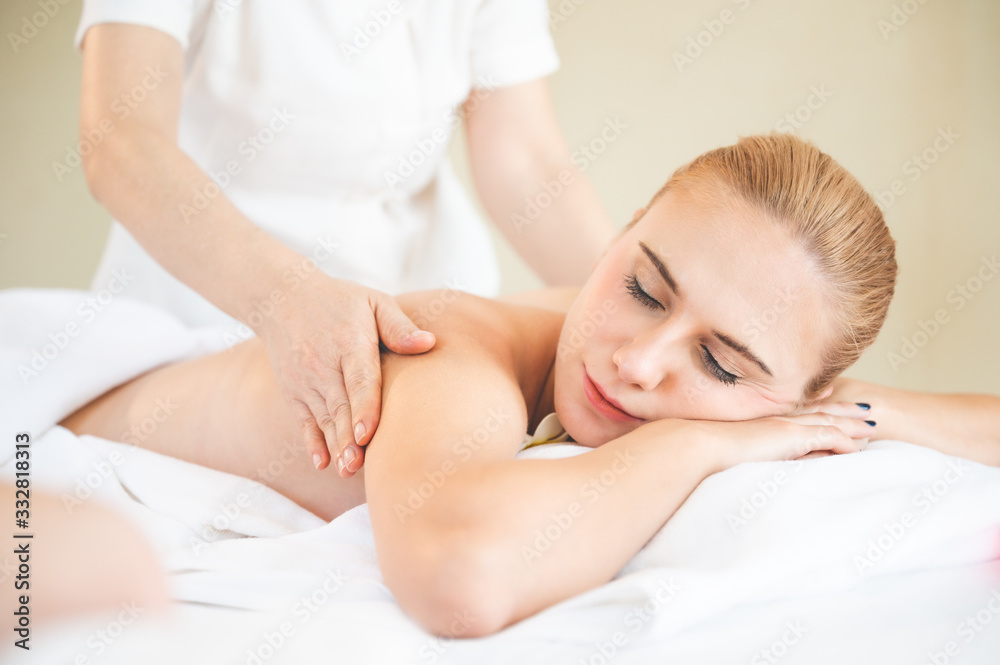 Health care and thai massage. Beautiful woman getting back and shoulder massage in spa salon Health care and thai massage. Beautiful woman getting back and shoulder massage in spa salon