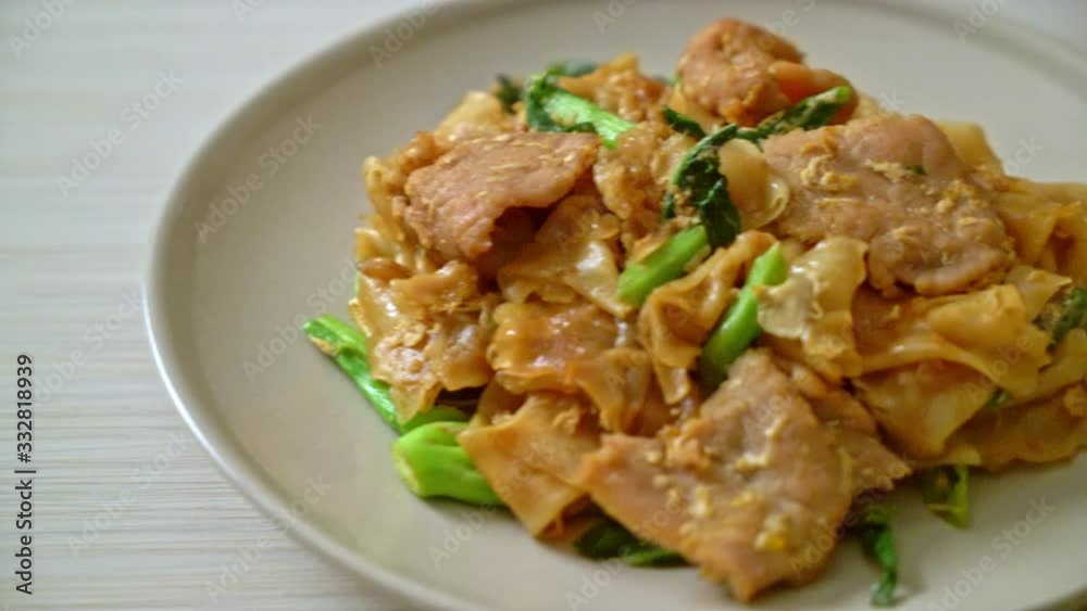 Stir-fried rice noodle with black soy sauce and pork and kale - Asian food style
