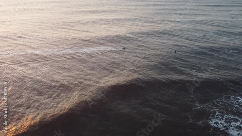 Aerial view. Drone flight over atlantic coast wavescrashing into sandy shore during sunset. Nature scenic beauty photo